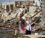 Two girls stand in rubble after a tornado struck Moore, Oklahoma, May 20, 2013. 
REUTERS/Gene Blevins