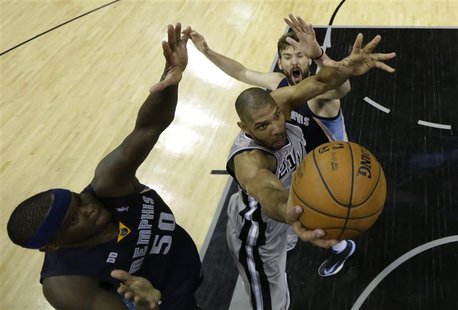 San Antonio Spurs forward Tim Duncan goes up for the shot as he is defended by Memphis Grizzlies forward Zach Randolph and center Marc Gasol San Antonio Spurs forward Tim Duncan goes up for the shot as he is defended by Memphis Grizzlies forward Zach Randolph and center Marc Gasol