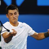 Bernard Tomic of Australia hits a return to Roger Federer of Switzerland during their men's singles match at the Australian Open tennis tour Bernard Tomic of Australia hits a return to Roger Federer of Switzerland during their men's singles match at the Australian Open tennis tour