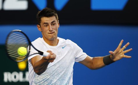 Bernard Tomic of Australia hits a return to Roger Federer of Switzerland during their men's singles match at the Australian Open tennis tour Bernard Tomic of Australia hits a return to Roger Federer of Switzerland during their men's singles match at the Australian Open tennis tour
