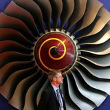 An exhibitor stands in front of a booth displaying Rolls-Royce aircraft engines on the first day of the 6th China International Aviation & A An exhibitor stands in front of a booth displaying Rolls-Royce aircraft engines on the first day of the 6th China International Aviation & A