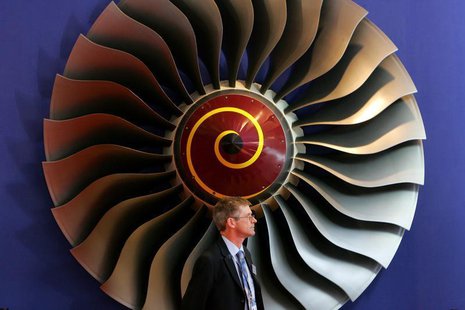 An exhibitor stands in front of a booth displaying Rolls-Royce aircraft engines on the first day of the 6th China International Aviation & A An exhibitor stands in front of a booth displaying Rolls-Royce aircraft engines on the first day of the 6th China International Aviation & A