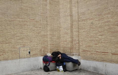 A homeless man sleeps in front of Saint Peter's Square in Rome March 7, 2013. REUTERS/Max Rossi A homeless man sleeps in front of Saint Peter's Square in Rome March 7, 2013. REUTERS/Max Rossi