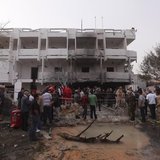 People stand among debris outside the French embassy after the building was attacked, in Tripoli April 23, 2013. REUTERS/Ismail Zitouny People stand among debris outside the French embassy after the building was attacked, in Tripoli April 23, 2013. REUTERS/Ismail Zitouny