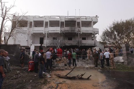 People stand among debris outside the French embassy after the building was attacked, in Tripoli April 23, 2013. REUTERS/Ismail Zitouny People stand among debris outside the French embassy after the building was attacked, in Tripoli April 23, 2013. REUTERS/Ismail Zitouny