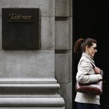 A woman walks past Telefonica's building in central Madrid March 26, 2013. REUTERS/Juan Medina