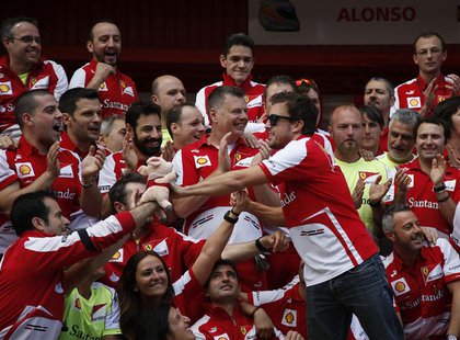 Ferrari Formula One driver Fernando Alonso of Spain (R) celebrates with his team after the Spanish F1 Grand Prix at the Circuit de Catalunya Ferrari Formula One driver Fernando Alonso of Spain (R) celebrates with his team after the Spanish F1 Grand Prix at the Circuit de Catalunya