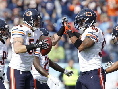 Chicago Bears line backer Brian Urlacher (54) celebrates with defensive end Julius Peppers (90) after recovering a fumble in the first half Chicago Bears line backer Brian Urlacher (54) celebrates with defensive end Julius Peppers (90) after recovering a fumble in the first half