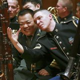 Musicians from the military bands of China's People's Liberation Army and the U.S. Army take photos during a rehearsal for their joint conce Musicians from the military bands of China's People's Liberation Army and the U.S. Army take photos during a rehearsal for their joint conce
