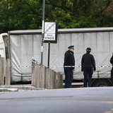 Police officers guard a cordon set up around a crime scene where one man was killed was killed in Woolwich, southeast London May 22, 2013. R