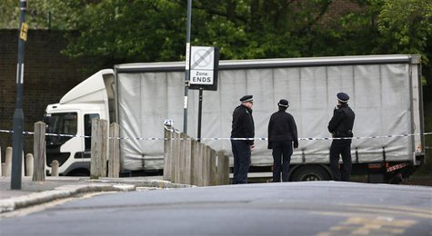 Police officers guard a cordon set up around a crime scene where one man was killed was killed in Woolwich, southeast London May 22, 2013. R Police officers guard a cordon set up around a crime scene where one man was killed was killed in Woolwich, southeast London May 22, 2013. R
