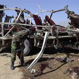 A security official searches for evidence near the remains of a damaged vehicle at the site of a bomb blast in Quetta May 23, 2013. REUTERS/ A security official searches for evidence near the remains of a damaged vehicle at the site of a bomb blast in Quetta May 23, 2013. REUTERS/