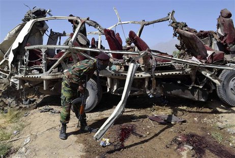 A security official searches for evidence near the remains of a damaged vehicle at the site of a bomb blast in Quetta May 23, 2013. REUTERS/ A security official searches for evidence near the remains of a damaged vehicle at the site of a bomb blast in Quetta May 23, 2013. REUTERS/
