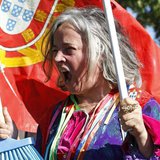 A woman with a Portuguese flag shouts slogans during a protest against austerity in front of the presidential palace in Lisbon May 20, 2013. A woman with a Portuguese flag shouts slogans during a protest against austerity in front of the presidential palace in Lisbon May 20, 2013.