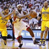 Miami Heat's LeBron James (C) drives through the defense of Indiana Pacers' Paul George (L) and David West on his way to making the game-win Miami Heat's LeBron James (C) drives through the defense of Indiana Pacers' Paul George (L) and David West on his way to making the game-win