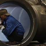 An employee welds a water turbine at a factory in Jinhua, Zhejiang province May 23, 2013. REUTERS/William Hong