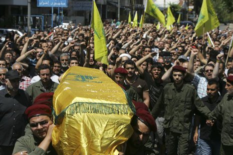 Supporters of Hezbollah and relatives of Hezbollah member Hussein Ahmad Abu Hasan carry his coffin during his funeral in Beirut's suburbs Ma Supporters of Hezbollah and relatives of Hezbollah member Hussein Ahmad Abu Hasan carry his coffin during his funeral in Beirut's suburbs Ma