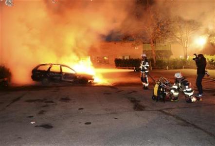 Firefighters extinguish a burning car, following riots in the Stockholm suburb of Kista late May 21, 2013, in this picture provided by Scanpix.
REUTERS/Fredrik Sandberg/Scanpix Firefighters extinguish a burning car, following riots in the Stockholm suburb of Kista late May 21, 2013, in this picture provided by Scanpix.
REUTERS/Fredrik Sandberg/Scanpix