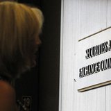 A woman waits for an elevator in the foyer of the Fort Worth Regional Office of the Securities and Exchange Commission (SEC) in Fort Worth, 