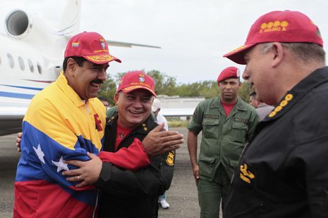 Venezuela's President Nicolas Maduro (L) embraces National Assembly President Diosdado Cabello while speaking to Defense Minister Diego Mole Venezuela's President Nicolas Maduro (L) embraces National Assembly President Diosdado Cabello while speaking to Defense Minister Diego Mole