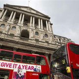 Buses pass the Bank of England in the City of London February 23, 2013. REUTERS/Neil Hall