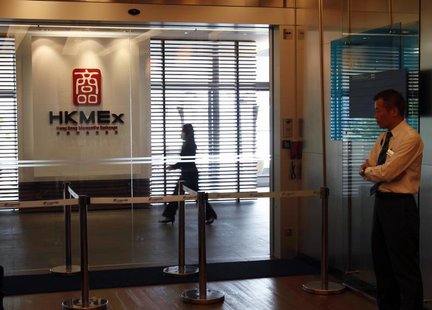 A security guard stands at the entrance as an office worker walks inside the Hong Kong Mercantile Exchange in Hong Kong May 23, 2013. REUTER A security guard stands at the entrance as an office worker walks inside the Hong Kong Mercantile Exchange in Hong Kong May 23, 2013. REUTER