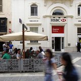 People sit in an outdoor coffee shop in front of an HSBC bank branch in Valletta May 8, 2013. REUTERS/Darrin Zammit Lupi