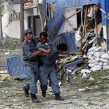 A wounded Afghan policeman (C) is helped away from the site of an explosion in Kabul May 24, 2013. REUTERS/Omar Sobhani A wounded Afghan policeman (C) is helped away from the site of an explosion in Kabul May 24, 2013. REUTERS/Omar Sobhani