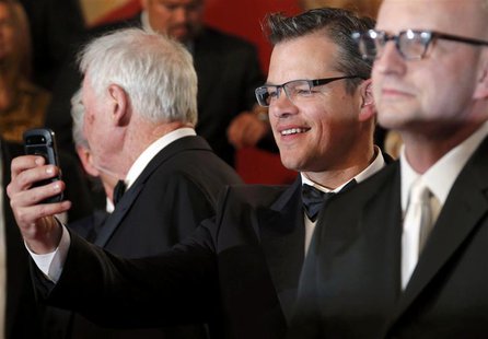 Cast member Matt Damon (C) takes pictures with his mobile phone after the screening of the film "Behind the Candelabra" by Steven Soderbergh Cast member Matt Damon (C) takes pictures with his mobile phone after the screening of the film "Behind the Candelabra" by Steven Soderbergh
