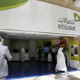 A customer walks out of an Etisalat shop at the Dubai World Trade Centre in Dubai October 14, 2012. REUTERS/Jumana ElHeloueh