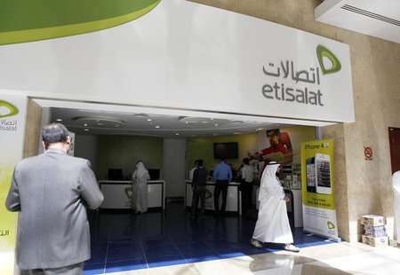 A customer walks out of an Etisalat shop at the Dubai World Trade Centre in Dubai October 14, 2012. REUTERS/Jumana ElHeloueh A customer walks out of an Etisalat shop at the Dubai World Trade Centre in Dubai October 14, 2012. REUTERS/Jumana ElHeloueh
