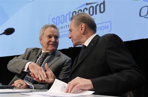 International Olympic Committee (IOC) President Jacques Rogge (R) shakes hands with IOC executive Denis Oswald during an IOC executive board International Olympic Committee (IOC) President Jacques Rogge (R) shakes hands with IOC executive Denis Oswald during an IOC executive board