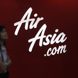 A customer reads an advertisement outside an AirAsia ticketing office in Kuala Lumpur August 29, 2012. REUTERS/Bazuki Muhammad A customer reads an advertisement outside an AirAsia ticketing office in Kuala Lumpur August 29, 2012. REUTERS/Bazuki Muhammad