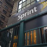 People walk past a Sprint store in New York December 17, 2012. REUTERS/Andrew Kelly