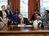 U.S. President Barack Obama signs a bill designating the Congressional Gold Medal commemorating the lives of the four young girls killed in 