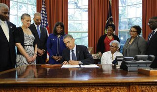 U.S. President Barack Obama signs a bill designating the Congressional Gold Medal commemorating the lives of the four young girls killed in 