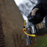 An Evanston police officer holds a firearm that was turned in as part of an amnesty-based gun buyback program in Evanston, Illinois December