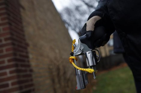 An Evanston police officer holds a firearm that was turned in as part of an amnesty-based gun buyback program in Evanston, Illinois December An Evanston police officer holds a firearm that was turned in as part of an amnesty-based gun buyback program in Evanston, Illinois December