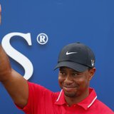 Tiger Woods reacts after being presented with The Players Championship trophy after winning the PGA golf tournament at TPC Sawgrass in Ponte
