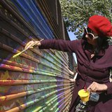 Artist Gretchen Baer paints on a fence marking the U.S. border in Naco, Mexico April 17, 2013. REUTERS/Tim Gaynor Artist Gretchen Baer paints on a fence marking the U.S. border in Naco, Mexico April 17, 2013. REUTERS/Tim Gaynor