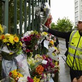 A worker adds flowers to other floral tributes to Drummer Lee Rigby, of the British Army's 2nd Battalion The Royal Regiment of Fusiliers, at