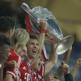 Bayern Munich's Arjen Robben holds the trophy with team mates after defeating Borussia Dortmund in their Champions League Final soccer match