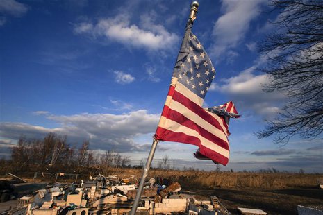 A tattered U.S. flag flies over the foundation of a home destroyed by the storm surge of superstorm Sandy in the Staten Island borough neigh A tattered U.S. flag flies over the foundation of a home destroyed by the storm surge of superstorm Sandy in the Staten Island borough neigh