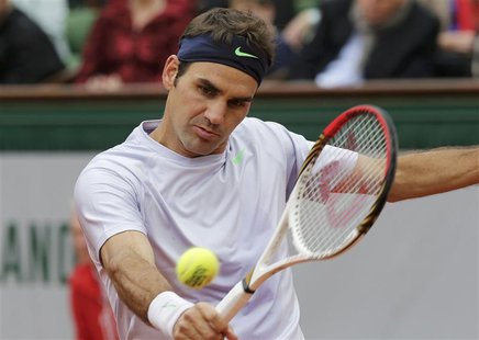 Roger Federer of Switzerland hits a return to Pablo Carreno-Busta of Spain during their men's singles match at the French Open tennis tourna Roger Federer of Switzerland hits a return to Pablo Carreno-Busta of Spain during their men's singles match at the French Open tennis tourna