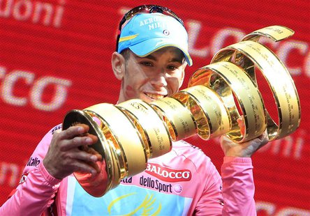 Pink jersey holder and overall leader Astana's Vincenzo Nibali of Italy holds the trophy as he celebrates after the 197km (122 miles) 21st a Pink jersey holder and overall leader Astana's Vincenzo Nibali of Italy holds the trophy as he celebrates after the 197km (122 miles) 21st a