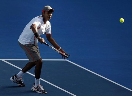 India's Mahesh Bhupathi hits a return during his and Sania Mirza's mixed doubles final match against China's Tiantian Sun and Serbia's Nenad India's Mahesh Bhupathi hits a return during his and Sania Mirza's mixed doubles final match against China's Tiantian Sun and Serbia's Nenad