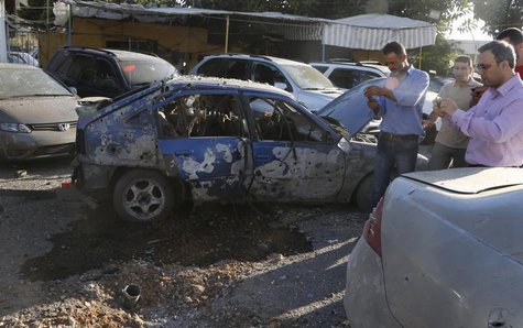 Residents inspect the remain of one of the two rockets that hit their residential area in Beirut suburbs May 26, 2013. REUTERS/Mohammed Azak Residents inspect the remain of one of the two rockets that hit their residential area in Beirut suburbs May 26, 2013. REUTERS/Mohammed Azak