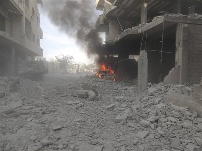 A car burns at a site hit by what activists said was shelling by forces loyal to Syria's President Bashar al-Assad in Arbaeen, near Damascus A car burns at a site hit by what activists said was shelling by forces loyal to Syria's President Bashar al-Assad in Arbaeen, near Damascus