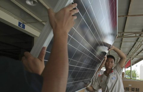 Employees examine newly-made solar panels before boxing for shipment at a factory of Yingli Solar in Baoding, Hebei province August 2, 2012. Employees examine newly-made solar panels before boxing for shipment at a factory of Yingli Solar in Baoding, Hebei province August 2, 2012.