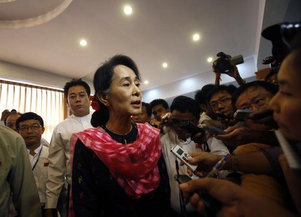 Myanmar pro-democracy leader Aung San Suu Kyi talks to reporters after giving a speech at the first meeting of the central executive committ Myanmar pro-democracy leader Aung San Suu Kyi talks to reporters after giving a speech at the first meeting of the central executive committ